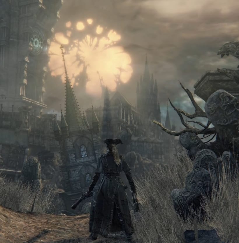 The player looks out over a brightly-lit Yharnam, with a yellow moon in the background that looks like it's decaying.