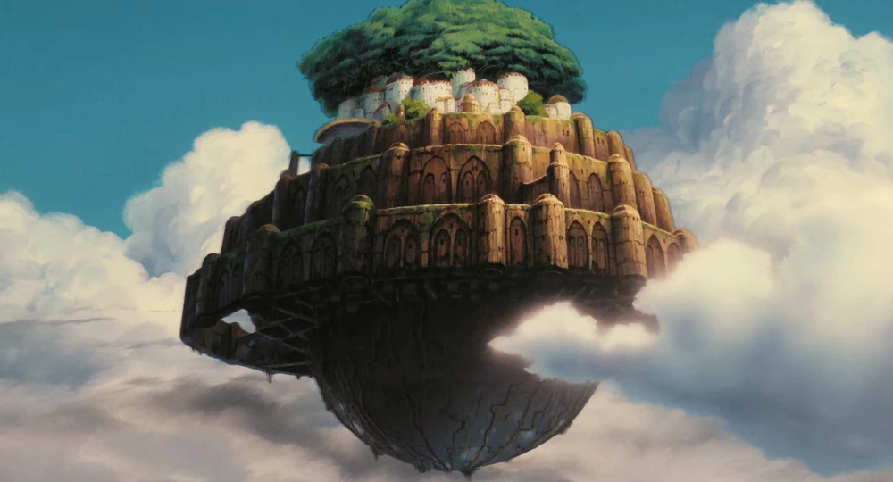 The floating island of Laputa from Studio Ghibli's film of the same name. It has several tiers of castle stone, and at the top is a cluster of white buildings with a giant tree. The bottom is rounded, and looks sci-fi.
